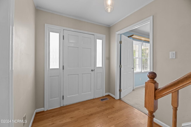 entrance foyer featuring light hardwood / wood-style floors and crown molding