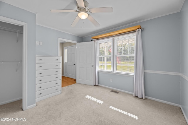 unfurnished bedroom featuring ornamental molding, light colored carpet, and ceiling fan