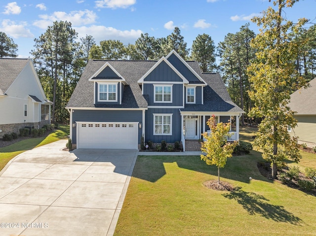 craftsman-style house with covered porch, a garage, and a front lawn