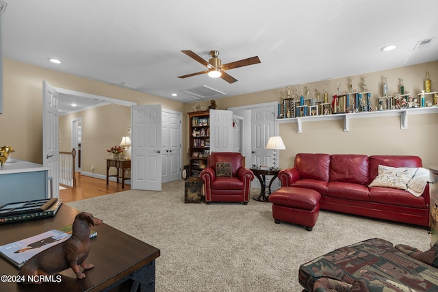 carpeted living room featuring ceiling fan