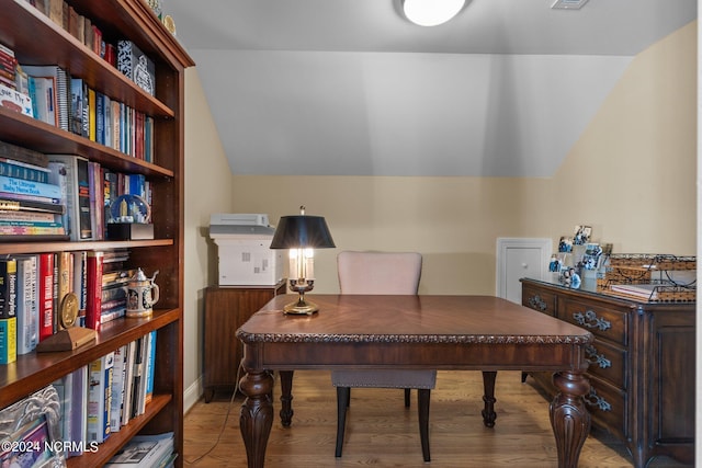 home office with lofted ceiling and light wood-type flooring