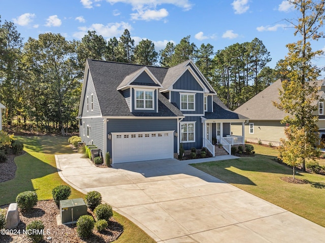 view of front of house with a porch, a front yard, and a garage