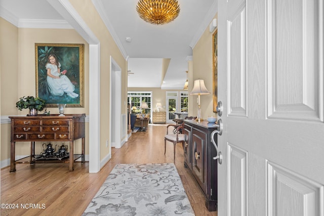 entryway featuring light hardwood / wood-style floors and ornamental molding