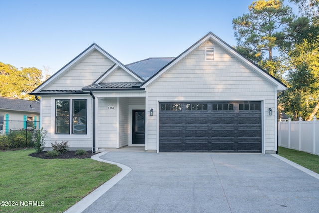 view of front facade featuring a front lawn and a garage