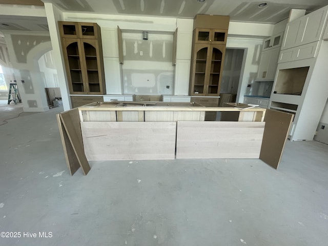 3413 Autumn Breeze Ct, Grimesland, NC 27837 - kitchen featuring concrete floors, a kitchen island, and glass insert cabinets