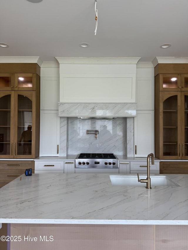 3413 Autumn Breeze Ct, Grimesland, NC 27837 - kitchen featuring range, decorative backsplash, glass insert cabinets, light stone counters, and recessed lighting