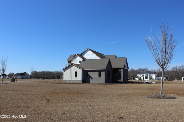 view of side of property with a yard