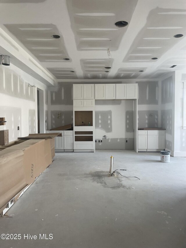 unfurnished living room with a towering ceiling