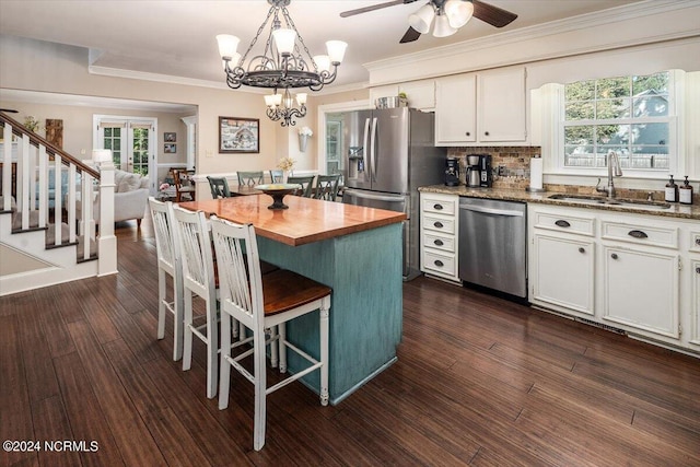 kitchen featuring dark hardwood / wood-style flooring, stainless steel appliances, white cabinetry, and sink