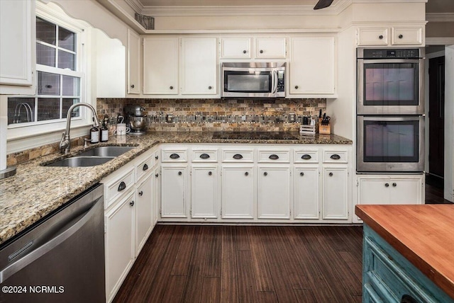 kitchen with white cabinets, appliances with stainless steel finishes, and sink