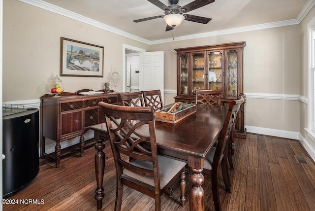 dining space with ceiling fan, dark wood-type flooring, and ornamental molding