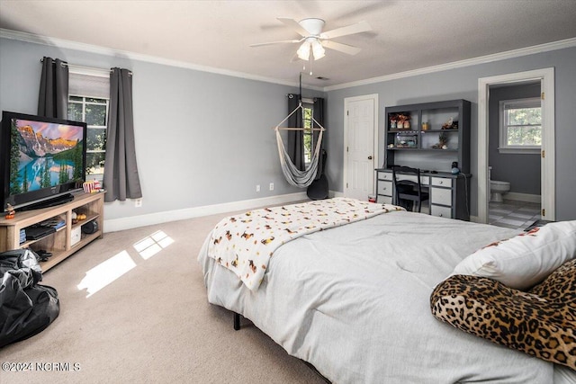 bedroom with carpet flooring, ensuite bathroom, ceiling fan, and ornamental molding