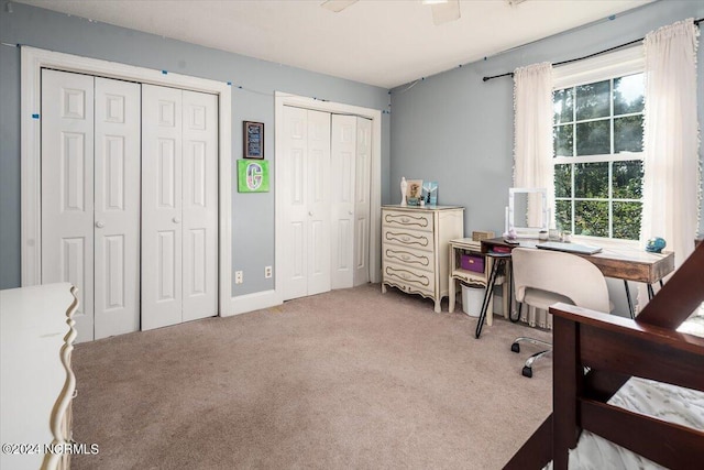 home office with light carpet and ceiling fan