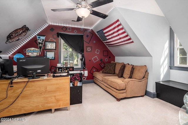 home office with carpet flooring, ceiling fan, and vaulted ceiling