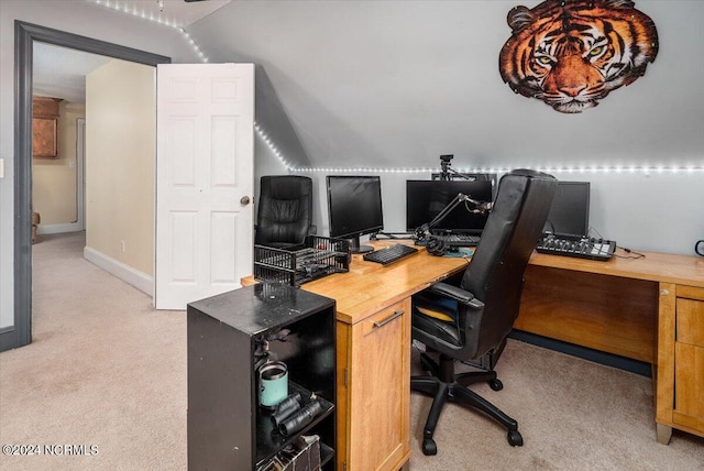 carpeted office space featuring lofted ceiling