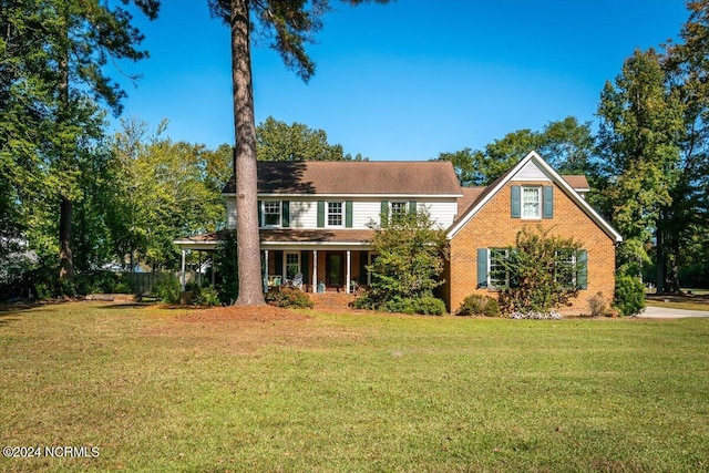 view of front of house with a front yard and covered porch