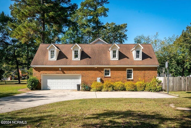 new england style home with a garage and a front lawn