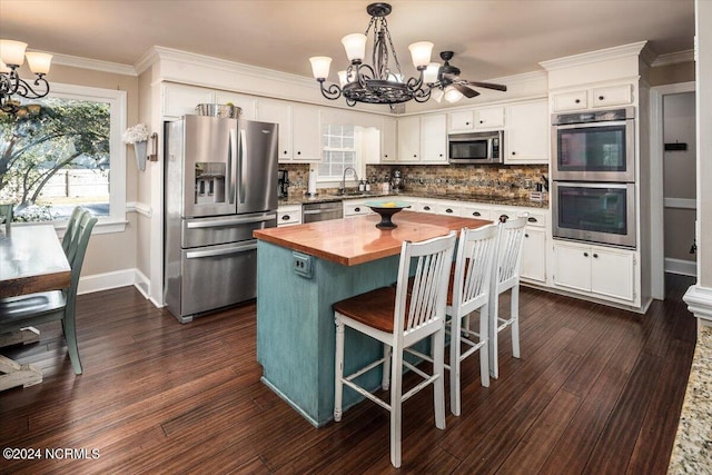 kitchen with white cabinetry, dark wood-type flooring, and stainless steel appliances