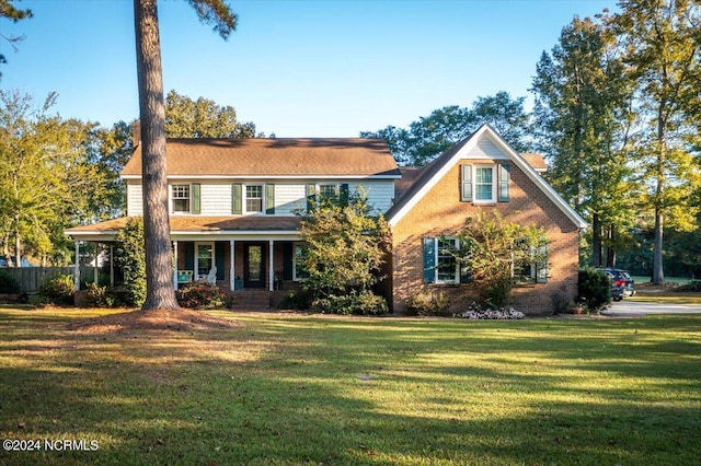 view of front of house featuring a porch and a front yard