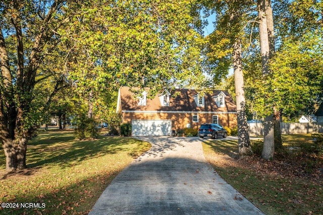 view of front of property with a garage and a front lawn