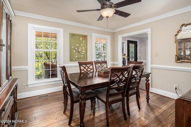 dining space with dark hardwood / wood-style flooring, plenty of natural light, and crown molding