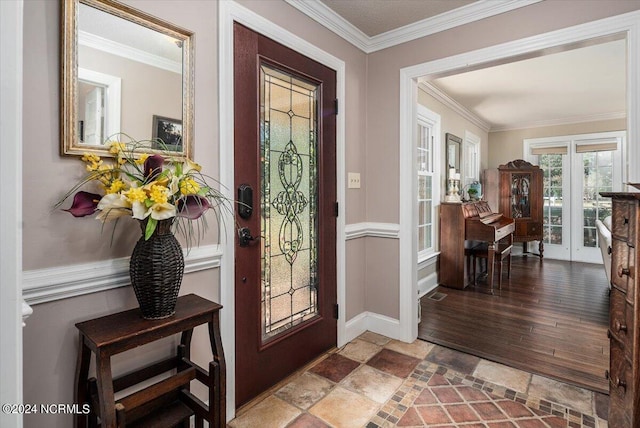 entrance foyer with hardwood / wood-style floors, ornamental molding, and french doors