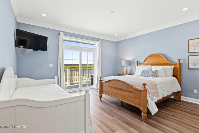 bedroom with access to exterior, ornamental molding, and light hardwood / wood-style flooring