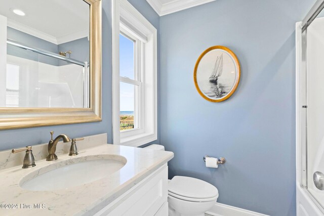 bathroom featuring toilet, an enclosed shower, vanity, and ornamental molding