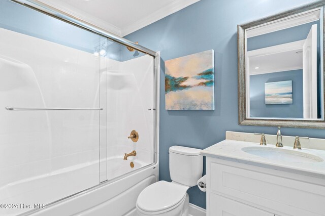 full bathroom with crown molding, vanity, combined bath / shower with glass door, and toilet