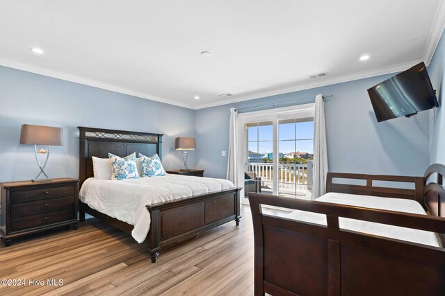 bedroom featuring light hardwood / wood-style floors, access to exterior, and ornamental molding