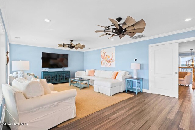 living room with wood-type flooring, ceiling fan, and crown molding