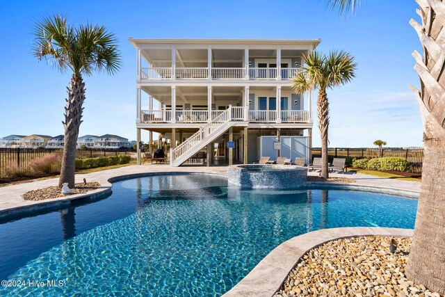 view of swimming pool with a patio and an in ground hot tub