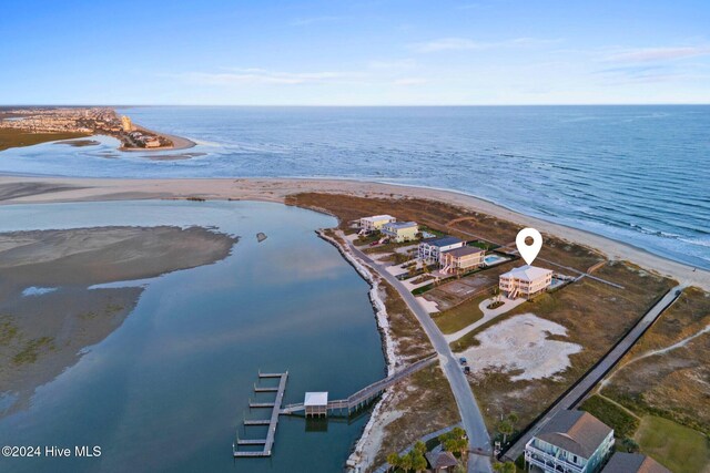 birds eye view of property with a view of the beach and a water view