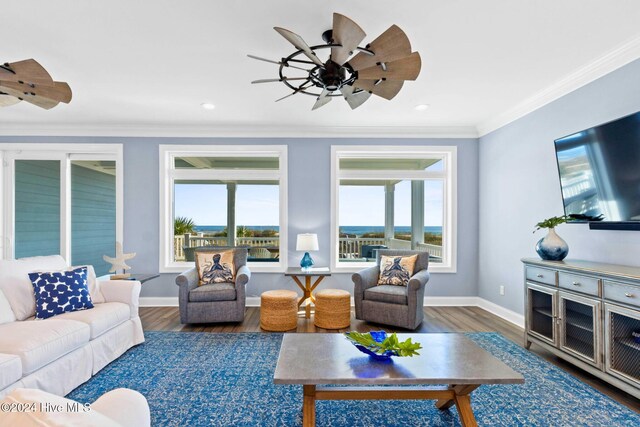 living room featuring ceiling fan, dark hardwood / wood-style floors, a healthy amount of sunlight, and crown molding