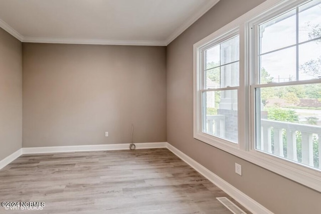 unfurnished room with ornamental molding and light hardwood / wood-style floors