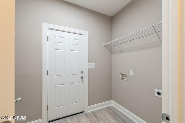 laundry area featuring hookup for an electric dryer, light hardwood / wood-style flooring, and hookup for a washing machine