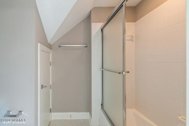 bathroom featuring walk in shower and lofted ceiling