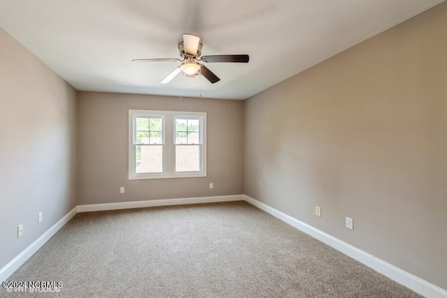 unfurnished room featuring ceiling fan and carpet