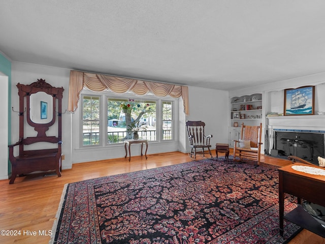 living room featuring wood-type flooring and a textured ceiling