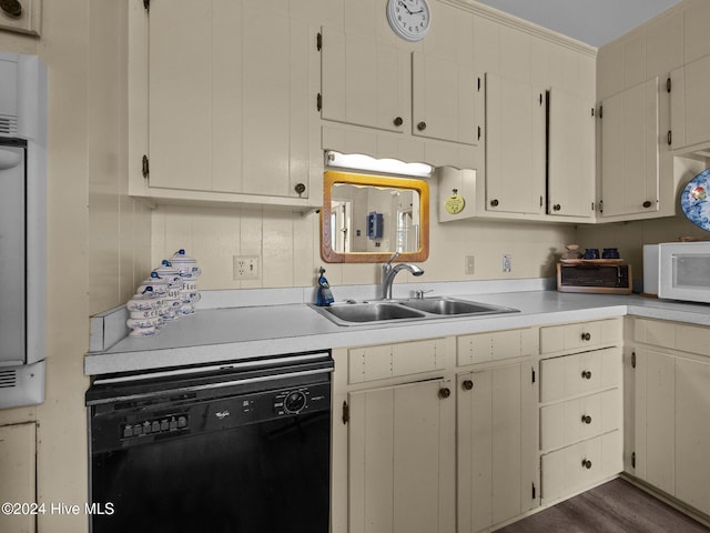 kitchen featuring black dishwasher, dark hardwood / wood-style flooring, and sink