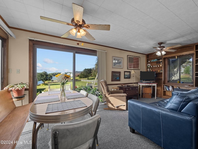 living room featuring ceiling fan, carpet flooring, and crown molding