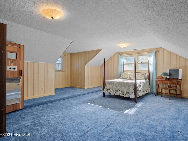 carpeted bedroom with lofted ceiling, a textured ceiling, and wooden walls