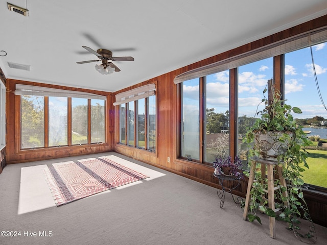 unfurnished sunroom with a healthy amount of sunlight and ceiling fan