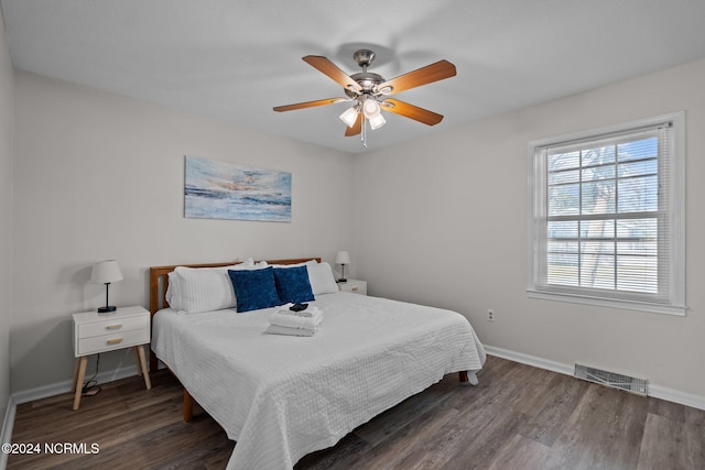 bedroom with dark wood-type flooring and ceiling fan