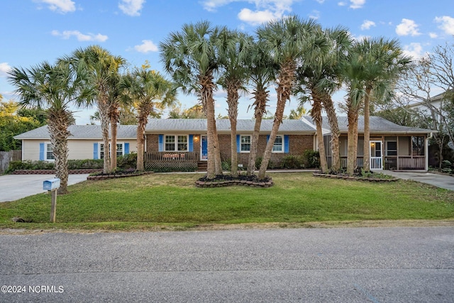 single story home featuring a front yard and a porch