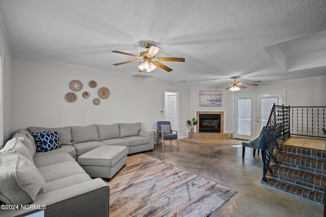 living room featuring ceiling fan, a textured ceiling, and concrete flooring