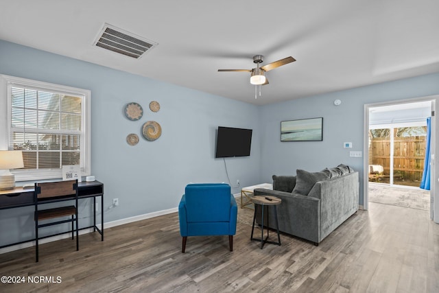 living room with ceiling fan, plenty of natural light, and hardwood / wood-style floors