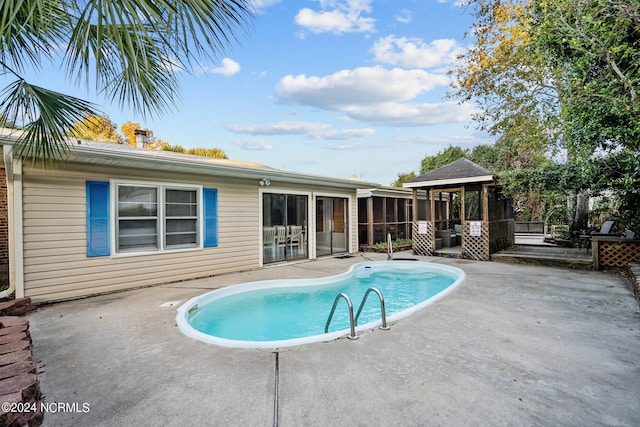 view of swimming pool with a gazebo and a patio area