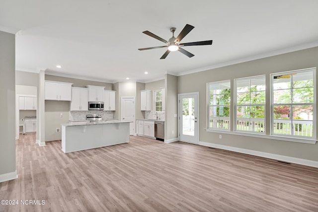 kitchen with white cabinetry, appliances with stainless steel finishes, light hardwood / wood-style flooring, and plenty of natural light