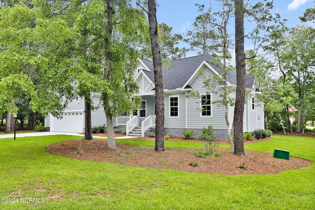 view of front facade with covered porch, a front yard, and a garage